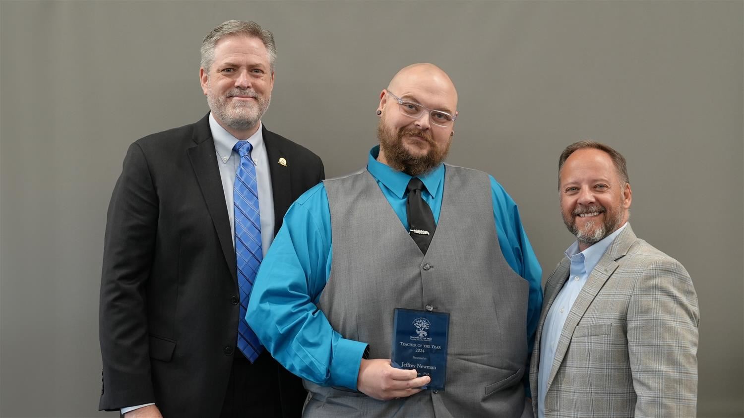 New Hope Education Center Teacher of the Year Jeffrey Newman pictured with Superintendent Steve Barnette and Paulding Educati