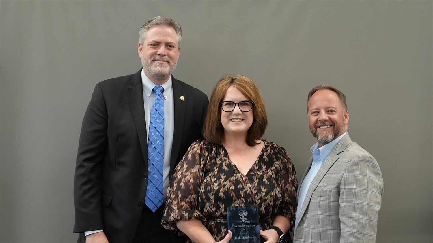 Roberts Elementary Teacher of the Year Monique Hart pictured with Superintendent Steve Barnette and Paulding Education Foundation Board member Jim McMichen.