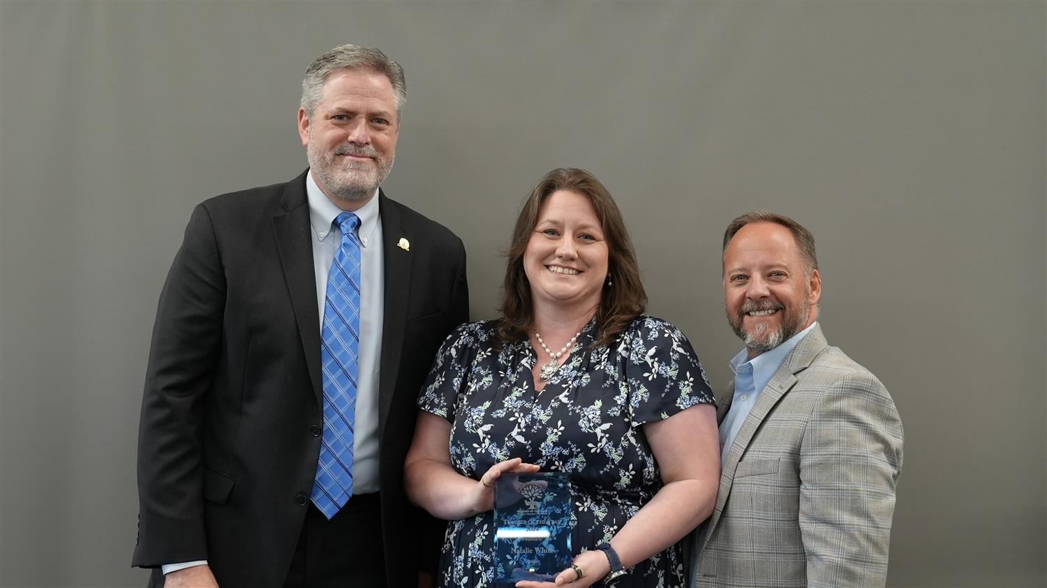 Scoggins Middle School Teacher of the Year Natalie White pictured with Superintendent Steve Barnette and Paulding Education Foundation Board member Jim McMichen.