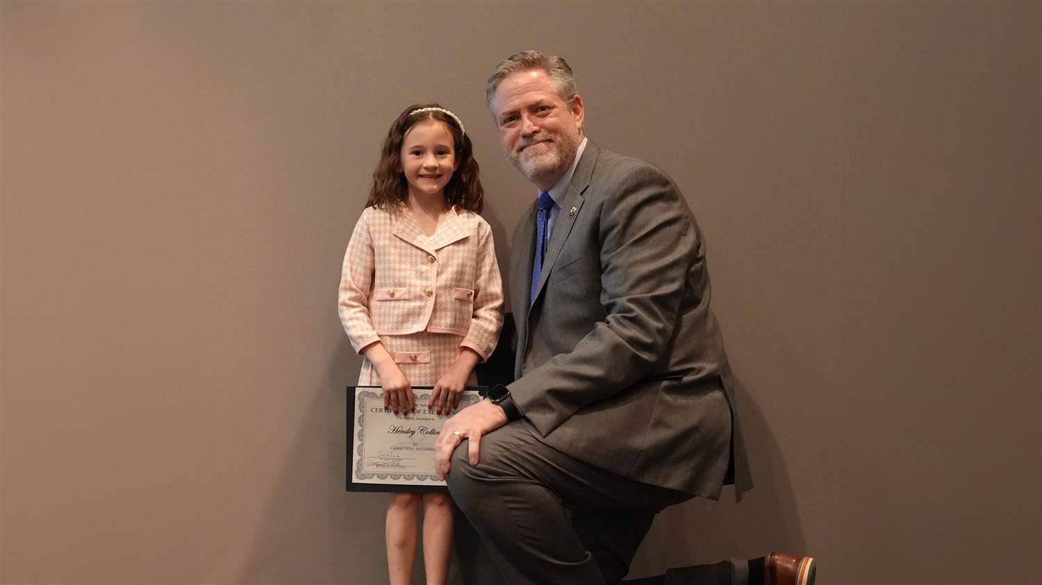 Superintendent Steve Barnette pictured with Visual Art winner Ragsdale ES 1st grader Hensley Collins.