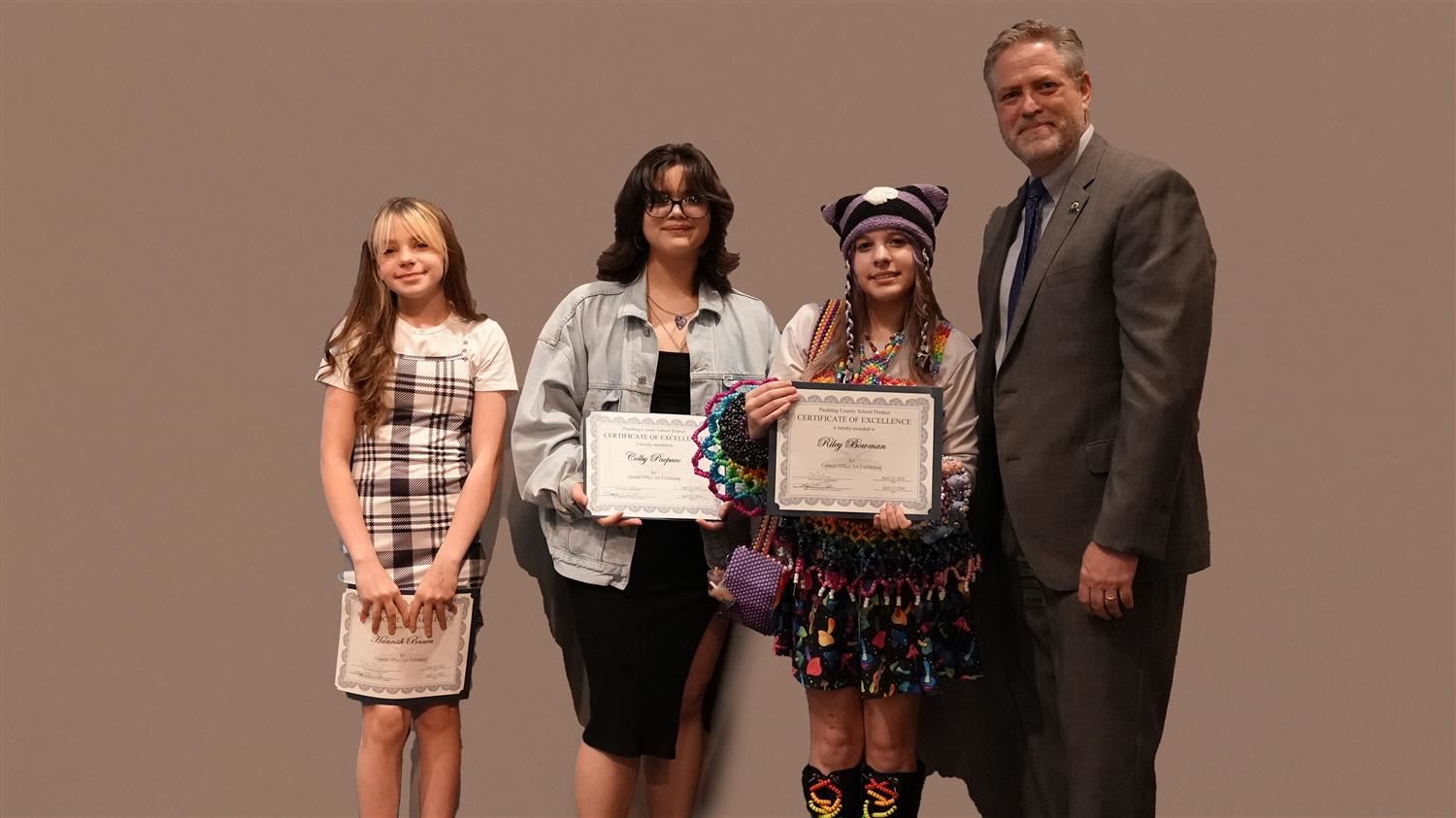 Superintendent Steve Barnette pictured with Visual Art winners Moses MS 6th grader Hannah Brown, McClure MS 8th grader Colby Pacpaco and Austin MS 7th grader Riley Bowman.