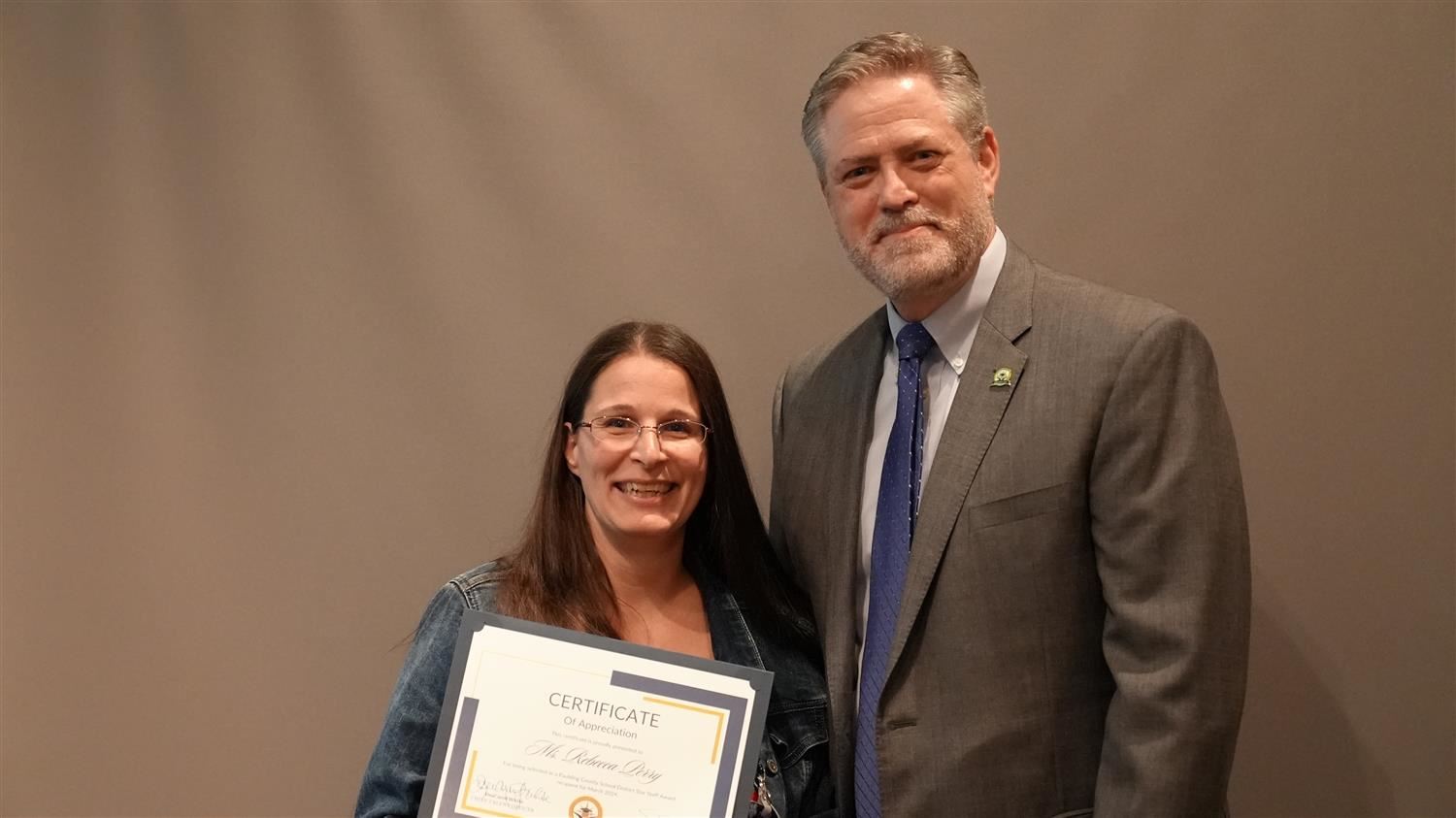 Superintendent Steve Barnette pictured with March 2024 Star Staff winner Central Registration Registrar Rebecca Perry.