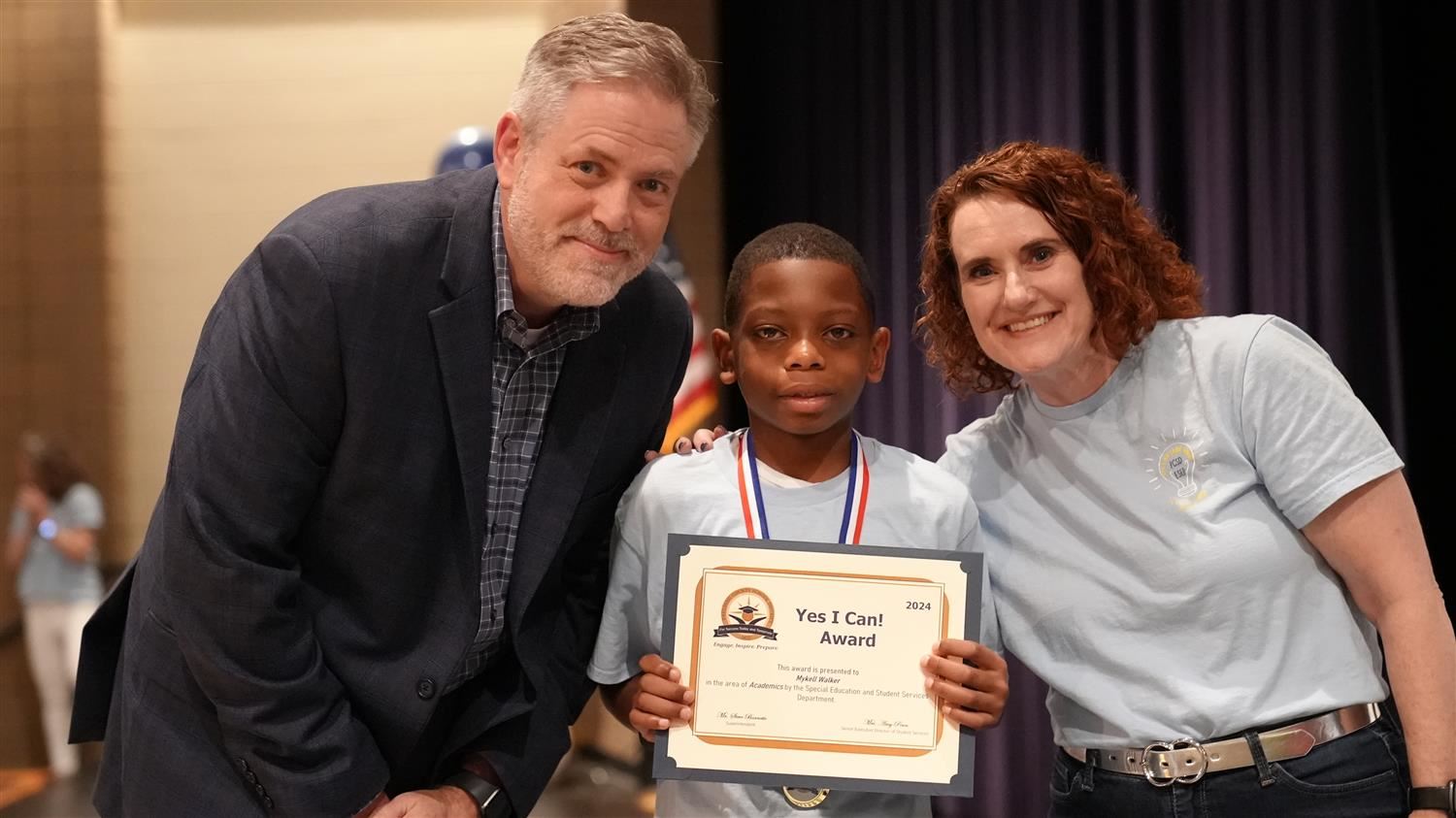 Mykell Walker from Hiram ES pictured with Superintendent Steve Barnette and Senior Executive Director of Student Services Amy