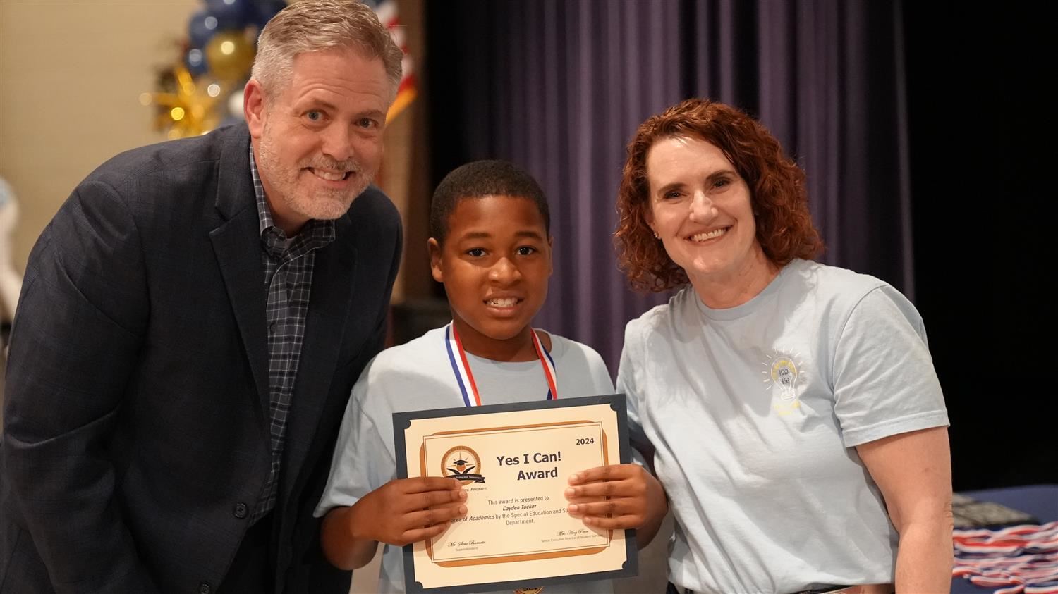 Cayden Tucker from Hutchens ES pictured with Superintendent Steve Barnette and Senior Executive Director of Student Services 