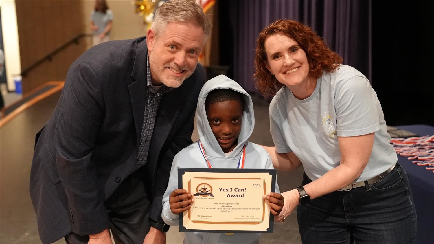 Aiden Boyd from Nebo ES pictured with Superintendent Steve Barnette and Senior Executive Director of Student Services Amy Pen