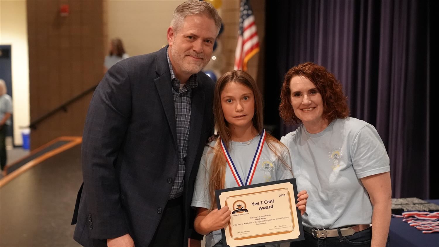 Brielle Wilson from Poole ES pictured with Superintendent Steve Barnette and Senior Executive Director of Student Services Am