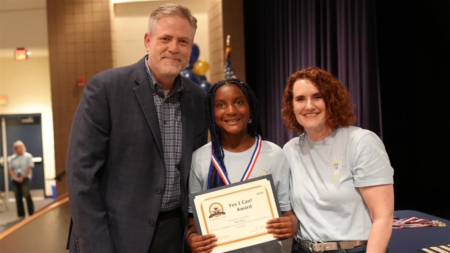 Akera Mosley from Shelton ES pictured with Superintendent Steve Barnette and Senior Executive Director of Student Services Am