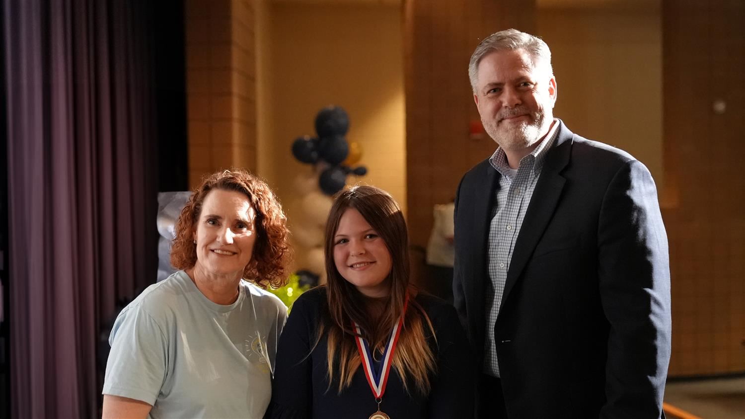 Lilly Callison from Moses Middle School pictured with Senior Executive Director of Student Services Amy Penn and Superintende