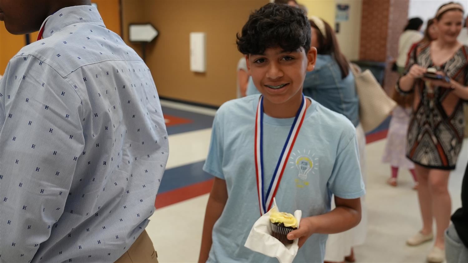 Middle School Yes I Can Winner enjoying a cupcake