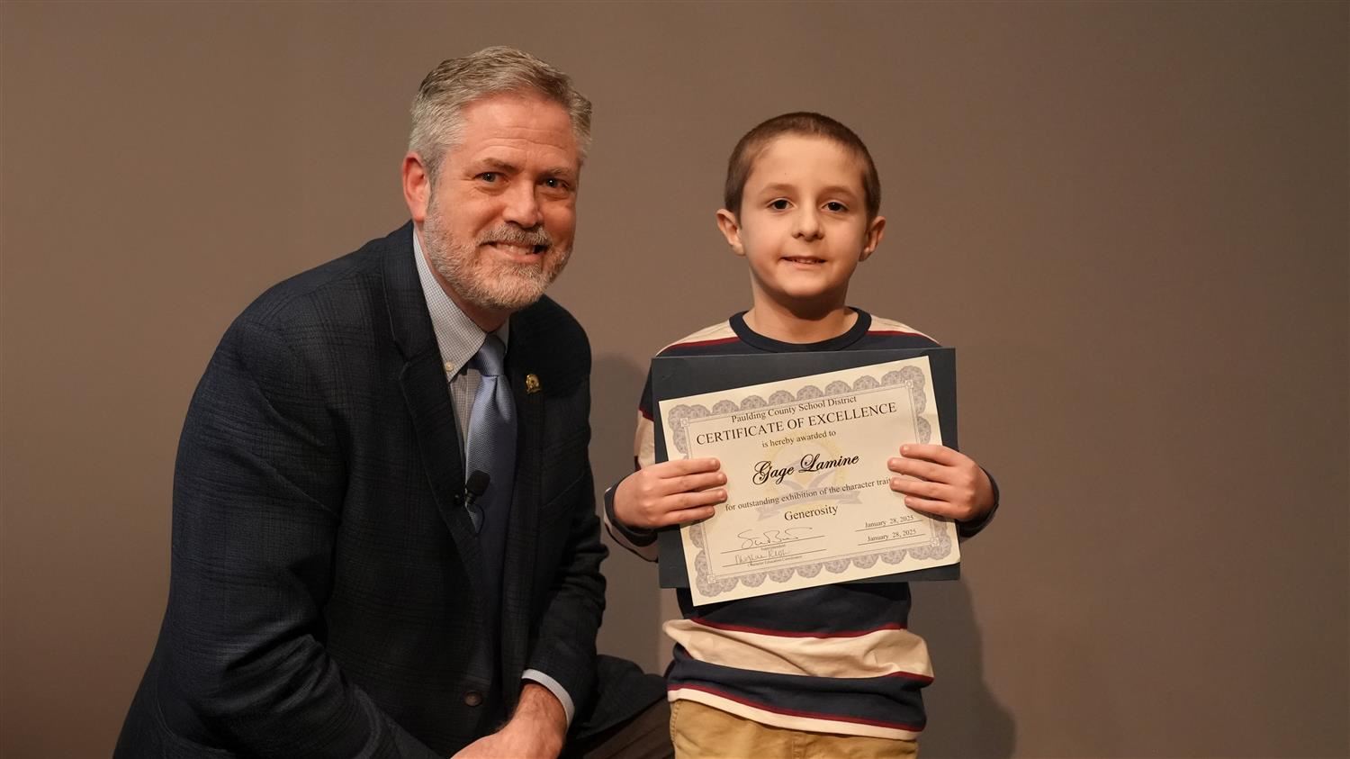 Character In Action - Generosity: Superintendent Steve Barnette and Gage Lamine from Poole Elementary.