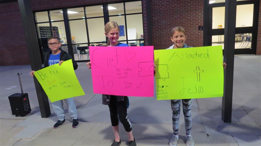 Students Holding Positive Signs